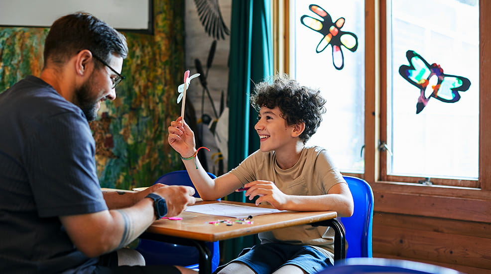 A man and young boy making crafts at WWT Dragonfly Festival
